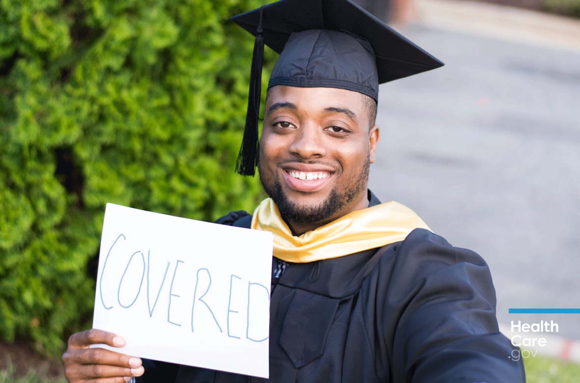 Image: {Graduate holding sign saying he has young adult health insurance coverage} 