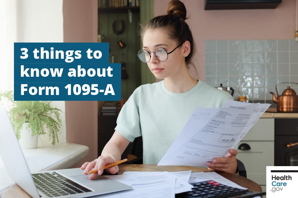 Image: {Woman reviews Form 1095-A to file taxes at computer}