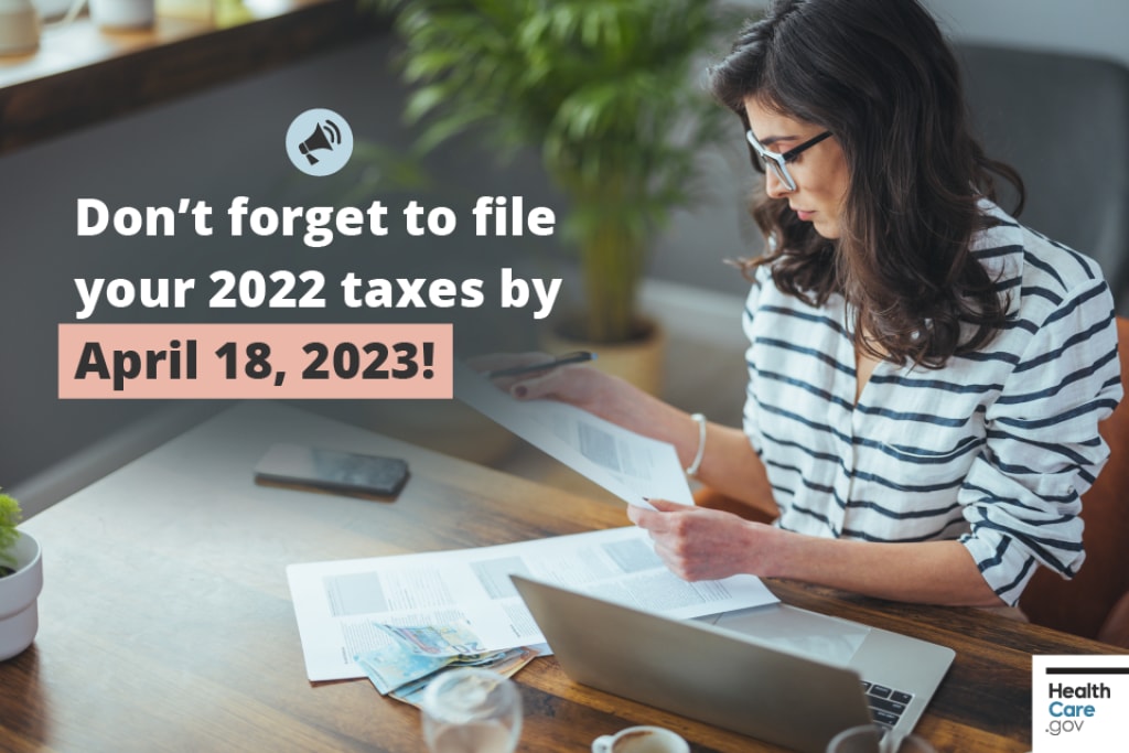 Don’t forget to file your 2022 taxes by April 18, 2023! Woman in striped sweater sits at her laptop computer with tax documents in her hand.