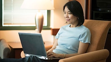 Woman reading fees information online